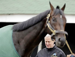 Trainer Todd Pletcher looks over Derby contender Revolutionary Monday morning at Churchill Downs.