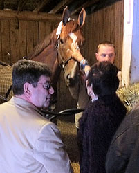 Eddie DeBartolo Jr. looks on as his wife Candy pets Life At Ten on the nose.