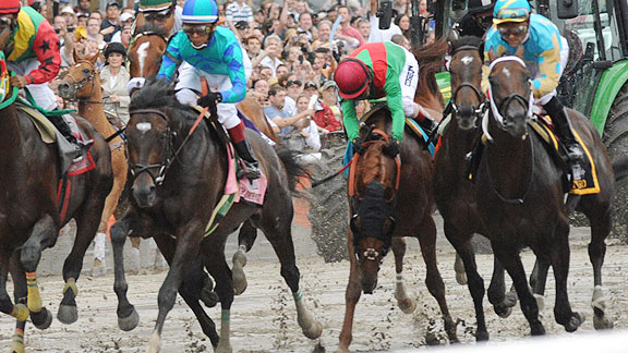 Jockey John Velazquez is almost unseated when Animal Kingdom is bumped leaving the starting gate in Saturday's Belmont Stakes.