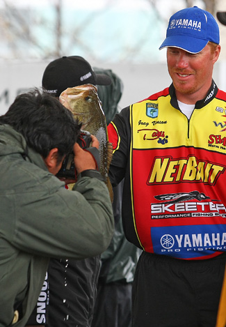 Greg Vinson holds up the biggest bass caught on Day Two