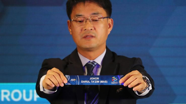 Shin Man Gil holds the name card of Johor Darul Ta'zim