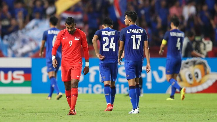 Singapore's Faritz Hameed shows his dejection as Thailand players celebrate in the background