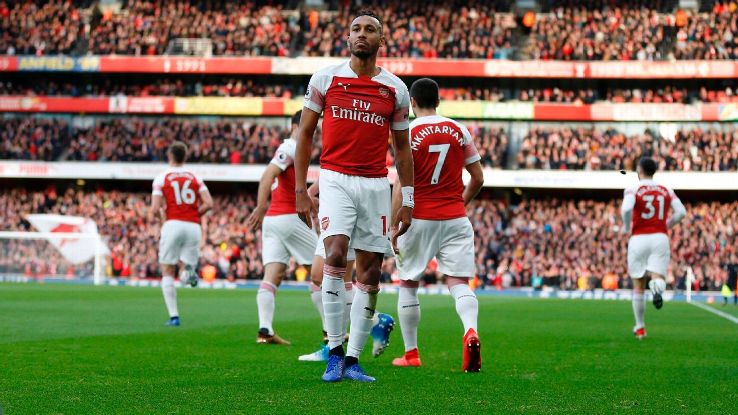 A banana thrown from the crowd is seen at the side of the pitch as Pierre-Emerick Aubameyang celebrates a goal for Arsenal