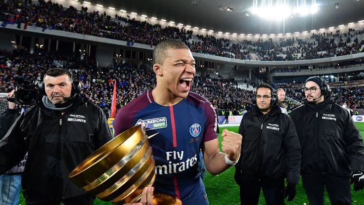 PSG's Kylian Mbappe lifts the Coupe de la Ligue trophy.
