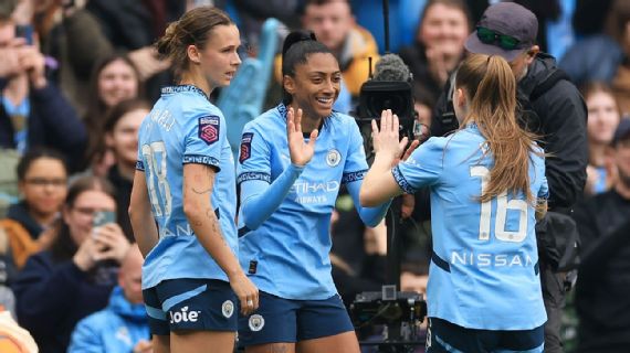 Man City players celebrate Kerolin's opening goal against Chelsea.