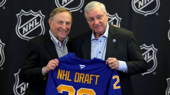 Commissioner Gary Bettman and Sabres owner Terry Pegula pose for a photo at a Monday news conference announcing Buffalo as the host of the 2026 NHL draft.