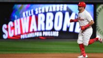 Boston Red Sox mascot Tessie The Green Monster performs on the infield  before a spring training baseball game against the Baltimore Orioles on  Thursday, March 17, 2016, in Fort Myers, Fla. (AP