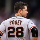 Buster Posey back with Giants after opting out, slinging diapers