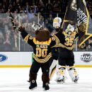 Bruins beat Devils 2-1, match NHL record with 62nd win