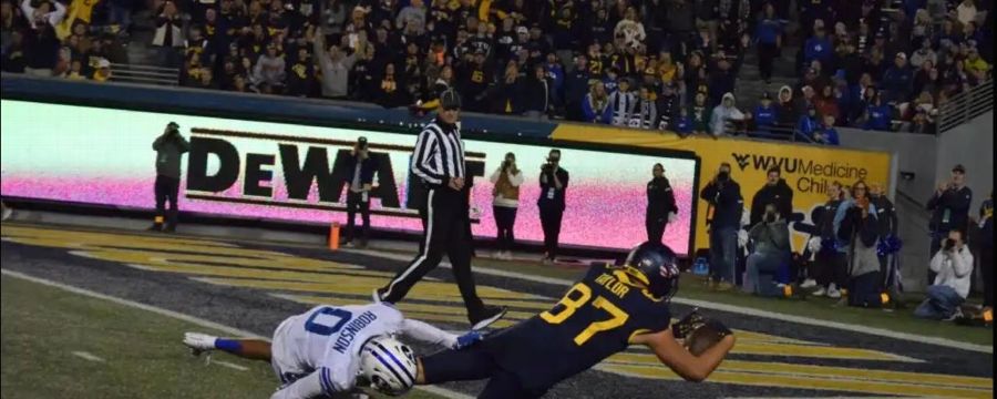 Kole Taylor splits a pair of defenders for a 43-yard WVU TD
