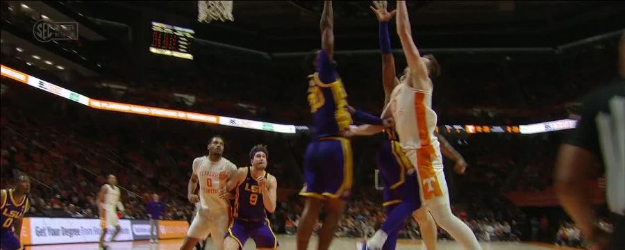 Dalton Knecht finishes over two LSU defenders for the and-1