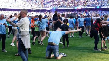 Manchester City fans storm the field as EPL crown is sealed