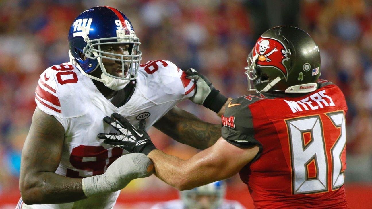 New York Giants defensive end jason Pierre-Paul stands over a fallen New  England Patriots quarterback Tom Brady during the fourth quarter at Super  Bowl XLVI at Lucas Oil Stadium on February 5