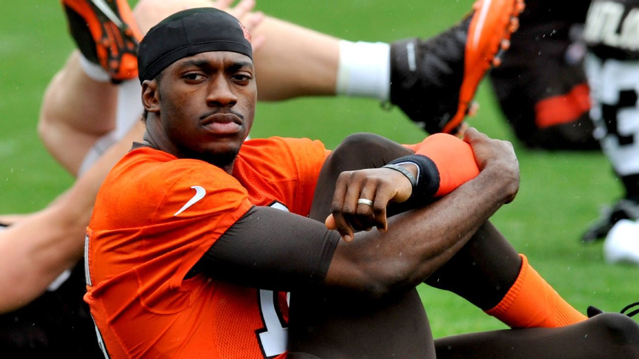 Baylor quarterback Robert Griffin III stands on the stage holding