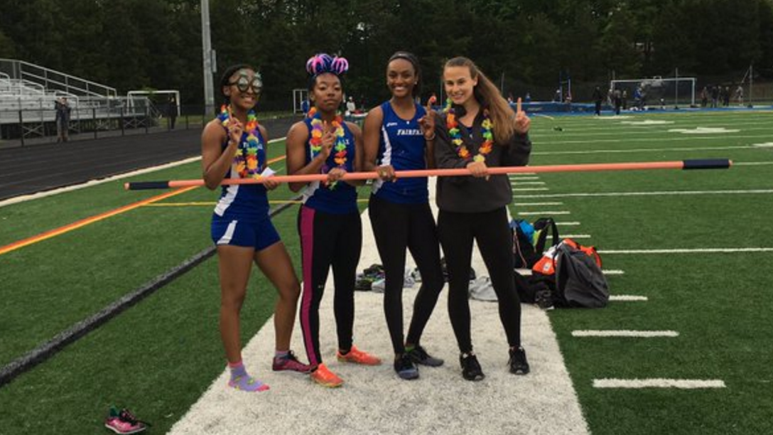 High school seniors win relay race with a high jump bar as a baton