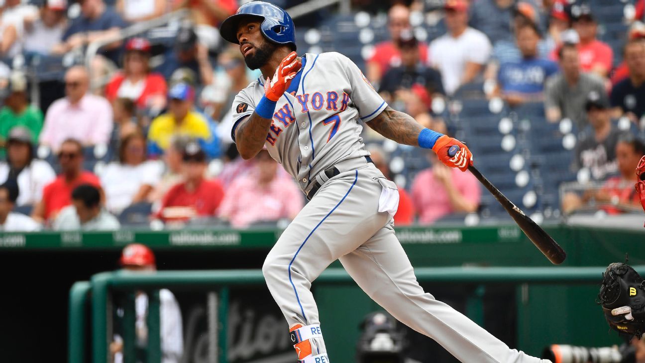 New York Mets' Jose Reyes, left, catches Philadelphia Phillies