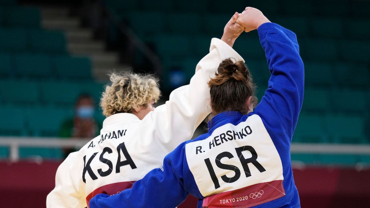 Saudi Arabian judoka and Israeli opponent clasp hands in solidarity after boycot..