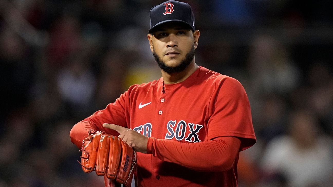 Red Sox pitcher Eduardo Rodriguez mimics Carlos Correa's watch gesture, drawing ..