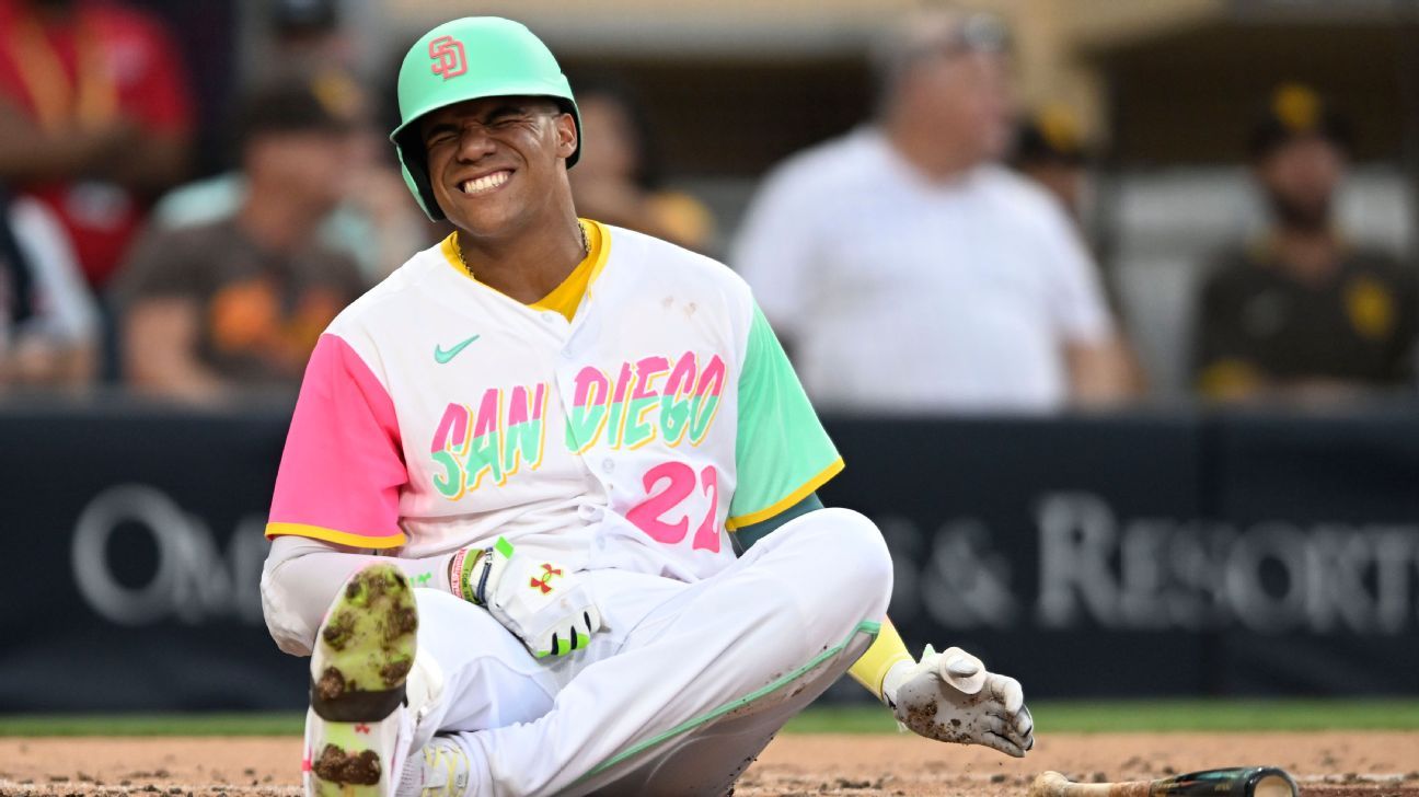 San Diego Padres' Juan Soto poses for a picture as he is covered by seeds  from teammates after hitting a home run during the first inning of a  baseball game against the