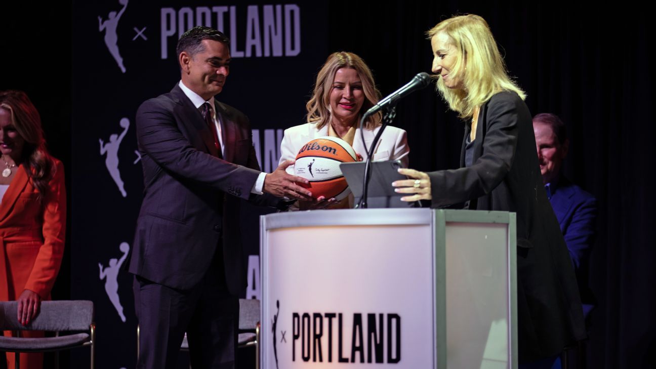New Portland Thorns owners Alex Bhathal and Lisa Bhathal Merage accept a WNBA ball from commissioner Cathy Engelbert as the Bhathals announce their new WNBA team, the Portland Fire, planned to debut next year.