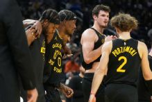 Warriors' Jimmy Butler helped off with knee injury vs. Heat