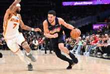 Suns' Devin Booker exits loss to Hawks after rolling right ankle