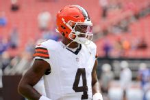 Signs calling out Deshaun Watson's past taped to Jim Brown statue