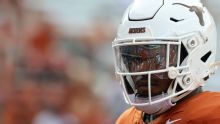 Texas' Colin Simmons penalized for miming urinating on field
