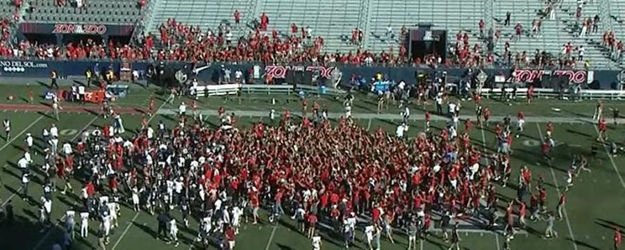 Students rush the field as the Wildcats end the nation's longest losing streak