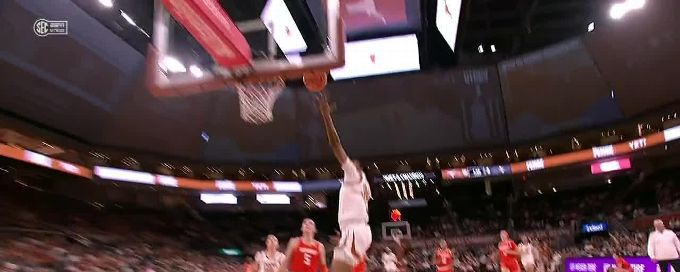 Madison Booker rises to block the shot