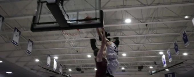 Caleb Kenney gets up for a huge poster before halftime