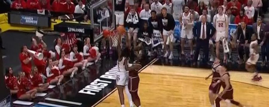 Xavier Amos elevates for the two-handed Wisconsin dunk