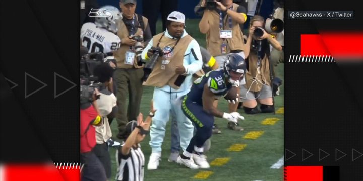 Marshawn Lynch protects his camera at all costs on sidelines