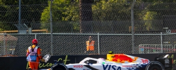 Liam Lawson narrowly avoids hitting marshals running across track