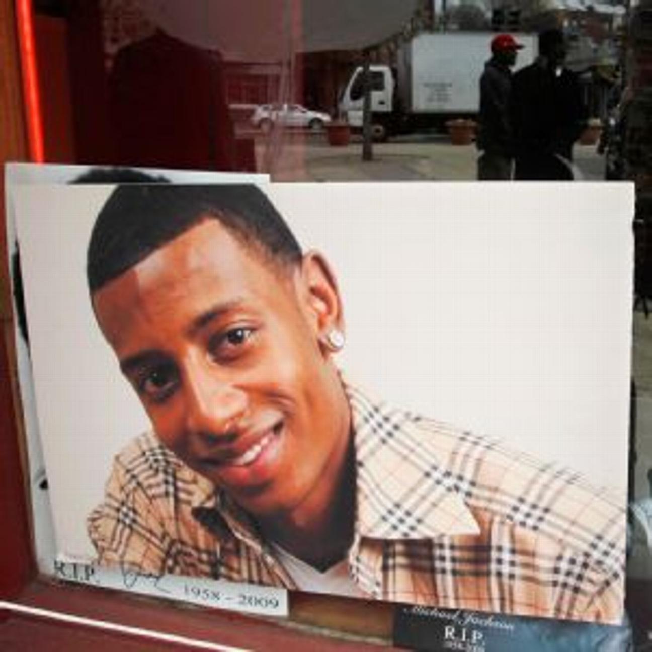 Danroy Henry Jr., seen above in a photo in the window of a radio station, was shot in his car as he drove through a parking lot away from a disturbance that spilled out of a bar on homecoming day.