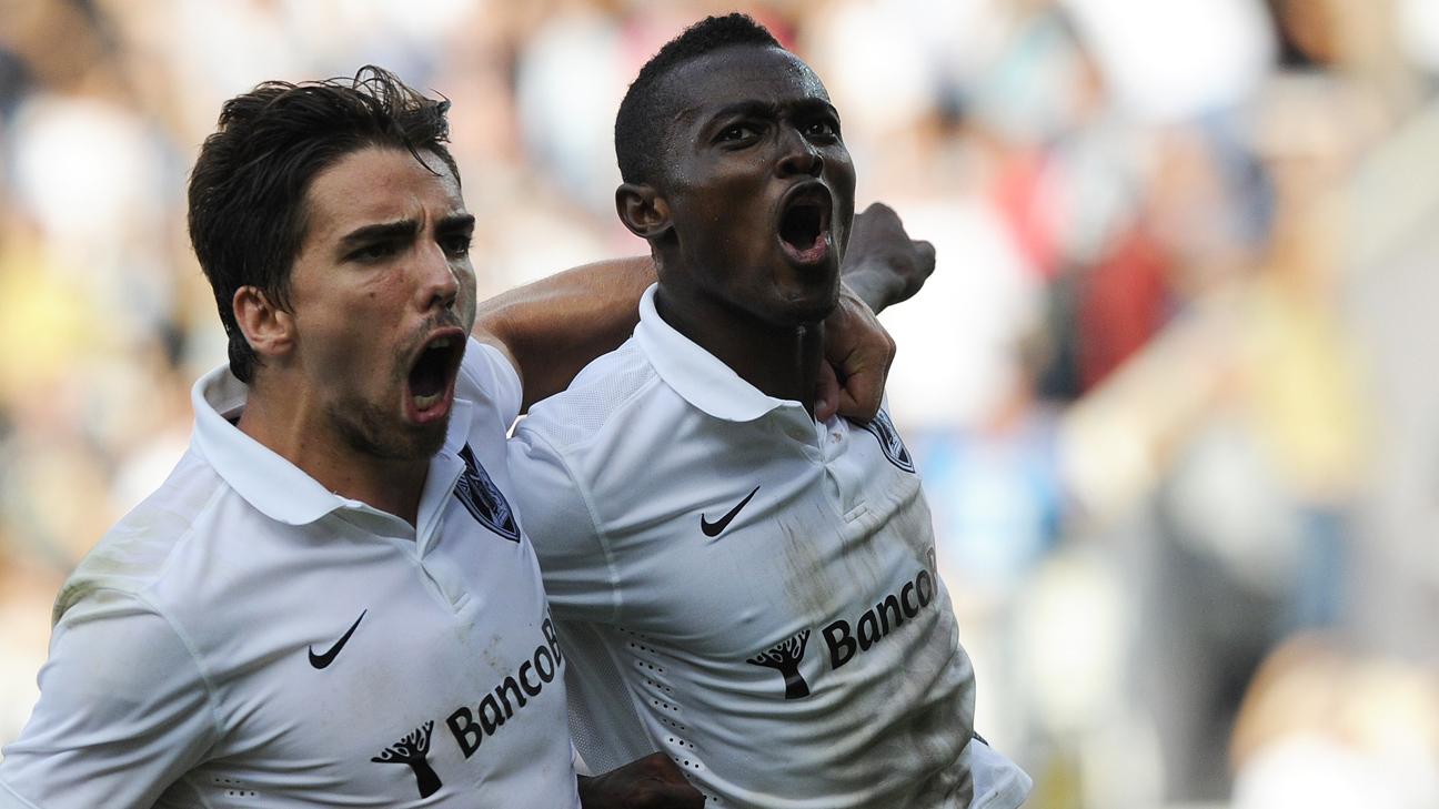 Vitoria SC's Ghanaian midfielder Bernard Mensah celebrates with teammate Tomane.