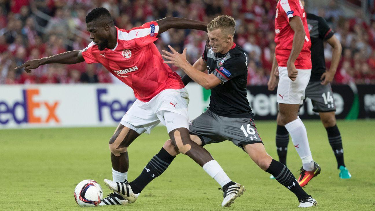 Hapoel Be'er Sheva's John Ogu holds off Southampton's James Ward-Prowse.