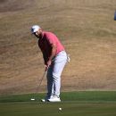 McIlroy tops Reed in duel at Dubai Desert Classic