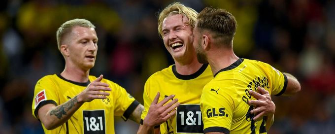 Ten-man Dortmund beat Hoffenheim 3-1 to take over top spot