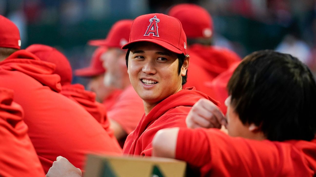 Ohtani returns to cheers, hugs in Angels' dugout