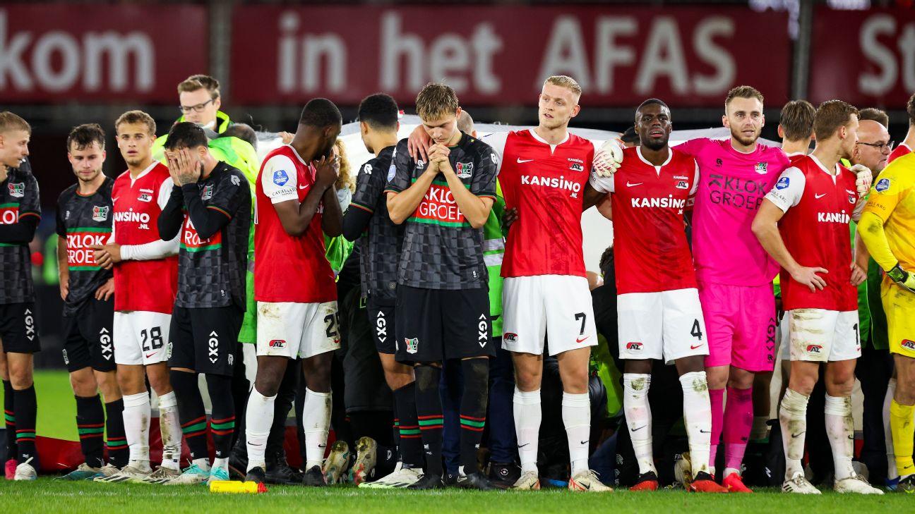 AZ Alkmaar and NEC Nijmegen gather on the field around Bas Dost after he collapsed during their Eredivisie match.