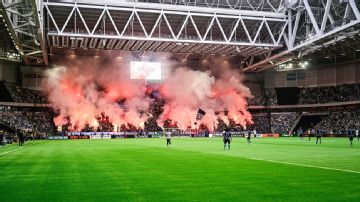 Stockholm derby suspended after fans throw pyrotechnics