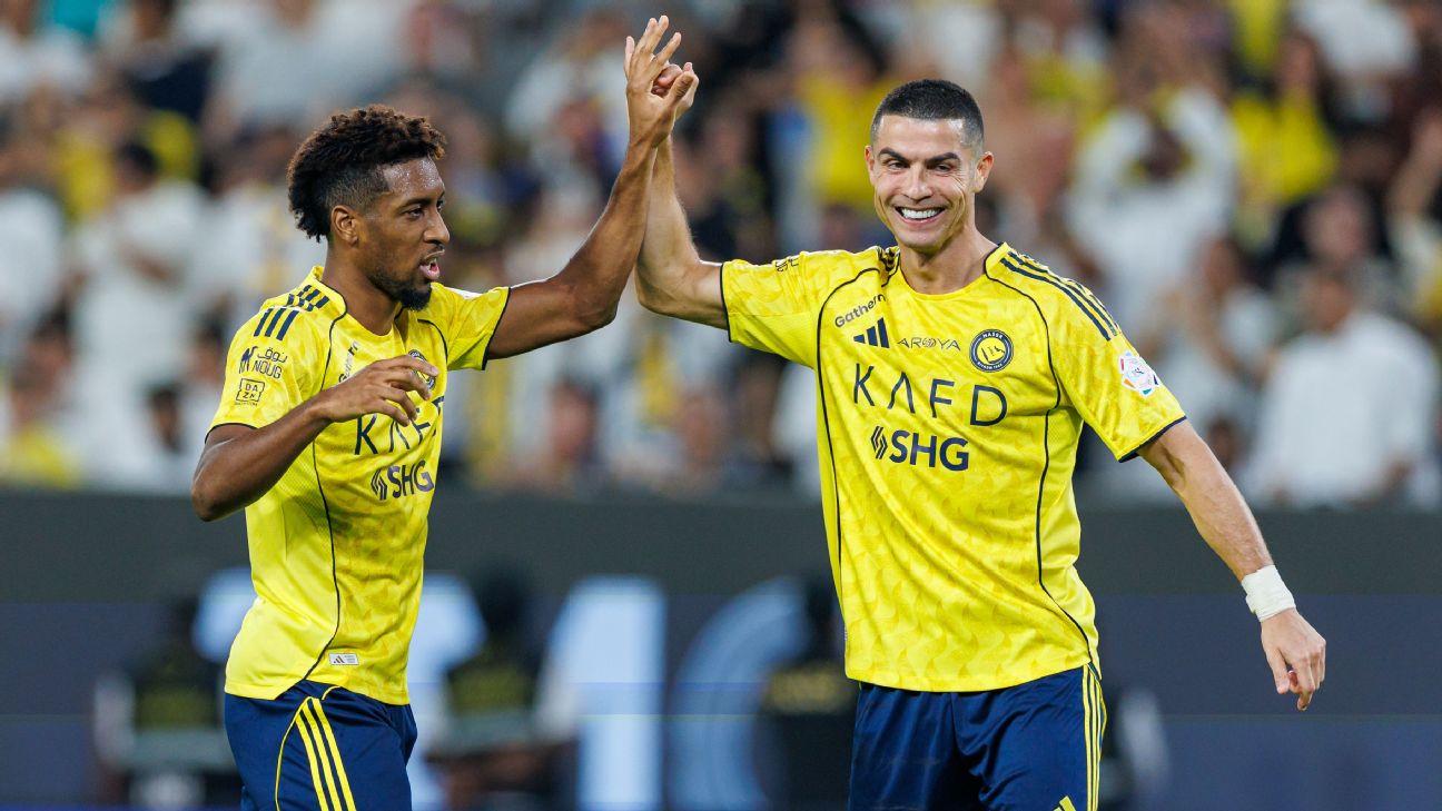 Cristiano Ronaldo celebrates with Kingsley Coman during Al Nassr's win over Al Fateh.