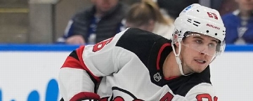 Hughes' 3rd career hat trick lifts surging Devils