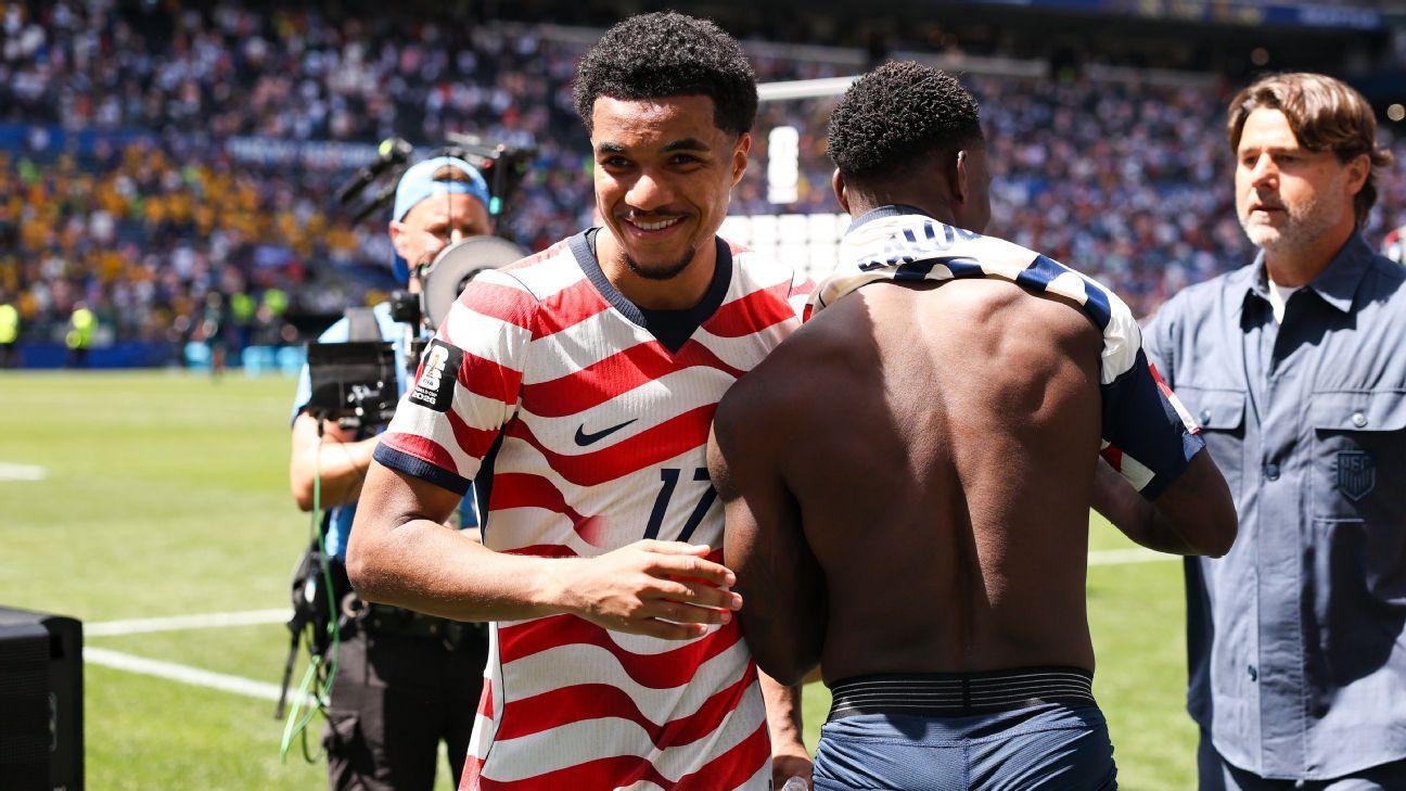 Midfielder Malik Tillman #17 and forward Folarin Balogun #20 of the United States hug