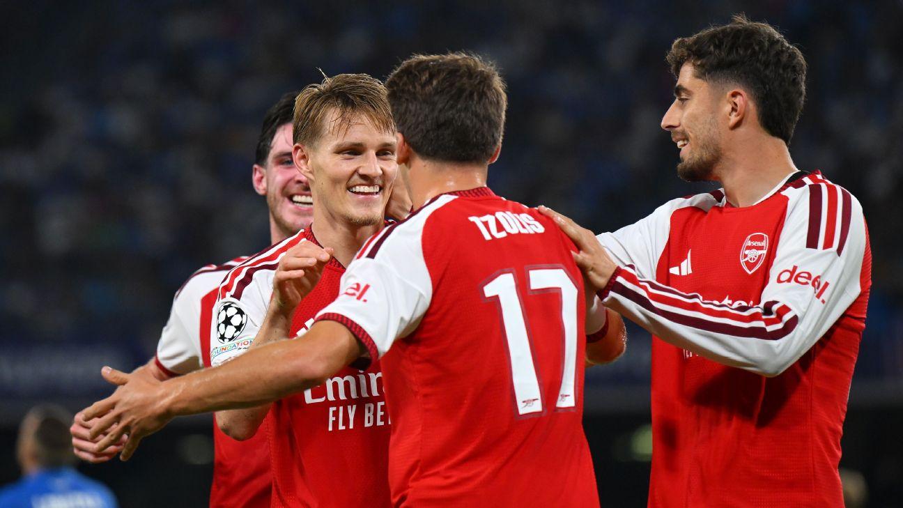 Arsenal players celebrate after scoring a goal against Napoli in the Champions League.