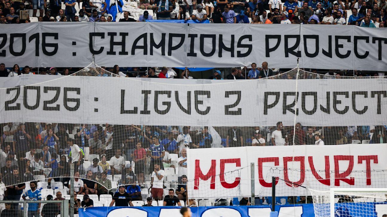 Marseille fans hold up banners in protest of U.S. owner Frank McCourt during the team's loss to PSG on Sunday.