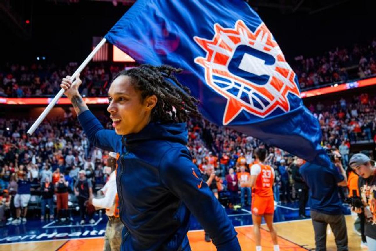 Brittney Griner carries a flag bearing the Sun logo after the team won its final game in Connecticut. The franchise, which finished 11-33, will move to Houston for the 2027 season.
