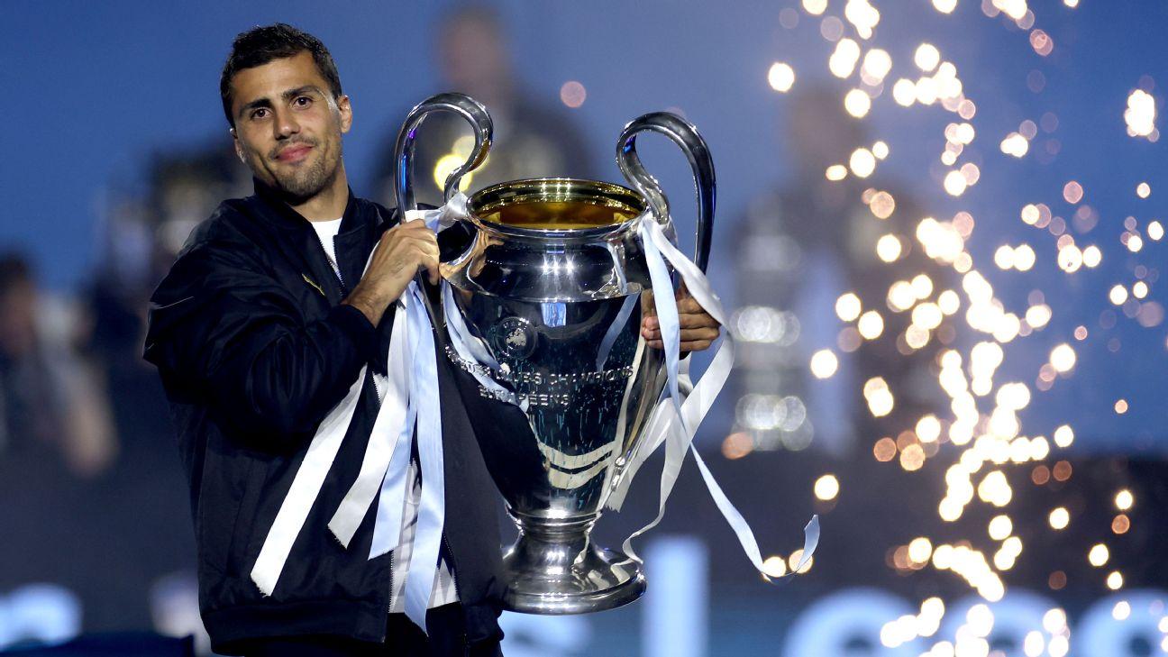 Rodri hold the Champions League trophy during a celebration of Man City's success in May.