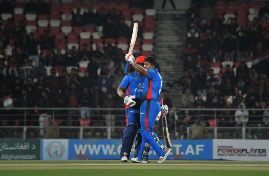 Hazratullah Zazai raises his bat after reaching his hundred — Article image accompanying Was Jos Buttler and Harry Brook's 233-run partnership against India a T20I record? on WagerUp Sports News. Hazratullah Zazai raises his bat after reaching his hundred — Article image accompanying Was Jos Buttler and Harry Brook's 233-run partnership against India a T20I record? on WagerUp Sports News.